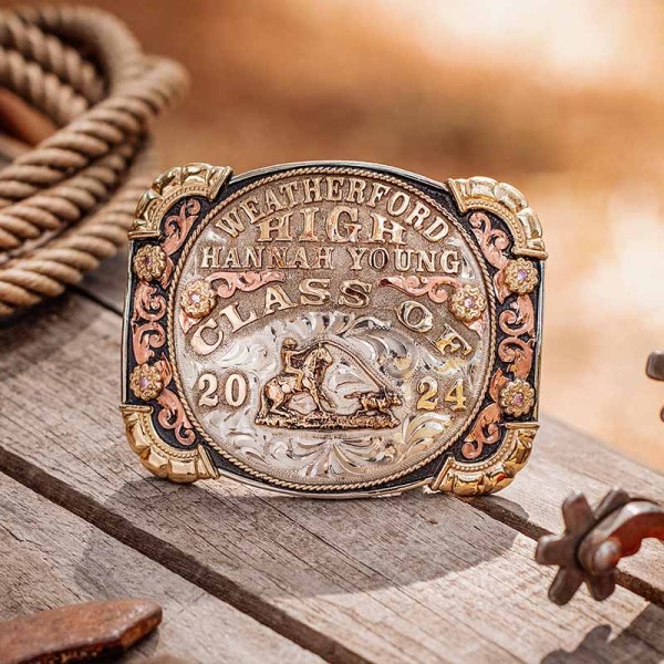 A custom class belt buckle for Weatherford High School with personalized name featuring a team roping figure 